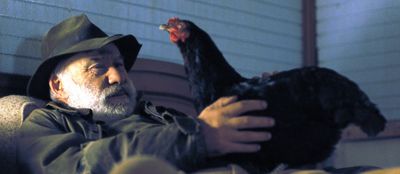 Der Restaurantbesitzer (Ioannis Kokiasmenos) mit dem Huhn