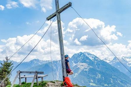 Auf dem Lechtaler Panoramaweg marschieren Wanderer über den Aussichtspunkt Lachenkopf mit freier Sicht über das Tiroler Lechtal