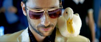 Y. (Ariel Bronz) spielt Piano mit einer Gans auf der Schulter