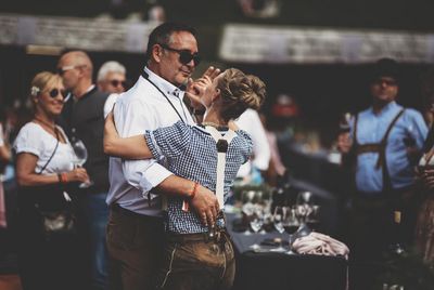 Bei Live-Musik feiern die Gaeste des The Unplugged Taste auf der Gompm Alm ueber Schenna in Suedtirol in Tracht