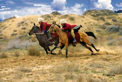 Turkmenische Reiter auf den beruehmten Achal Tekkiner Pferden